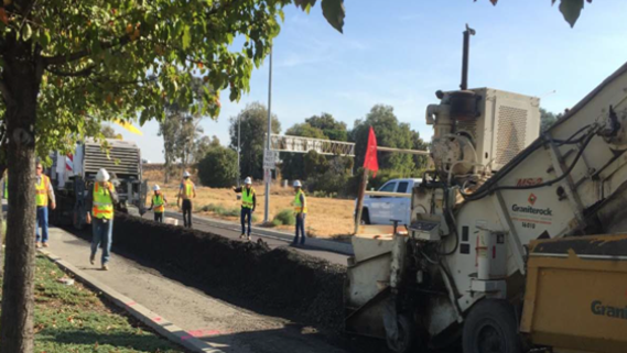 asphalt dumping onto East Monte Vista Road during repaving