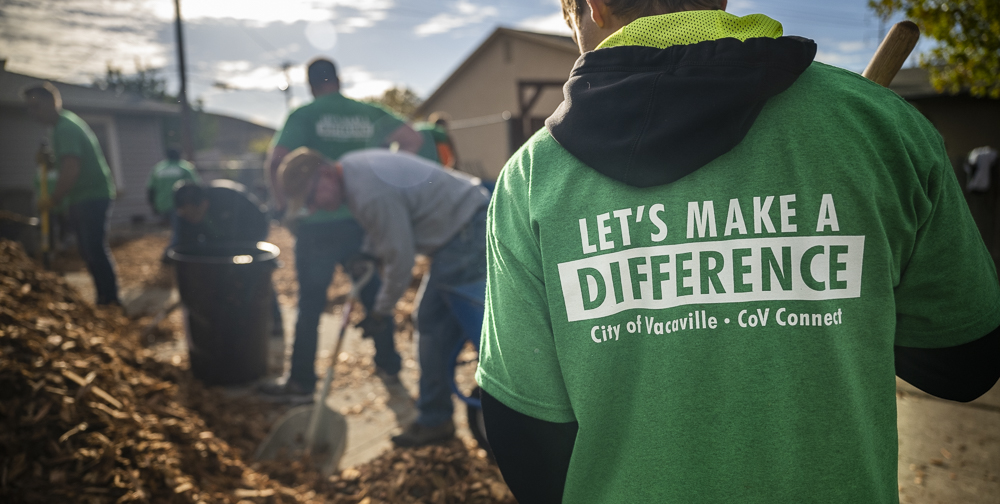 Volunteers cleaning a yard