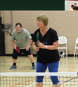 Two people playing badminton.