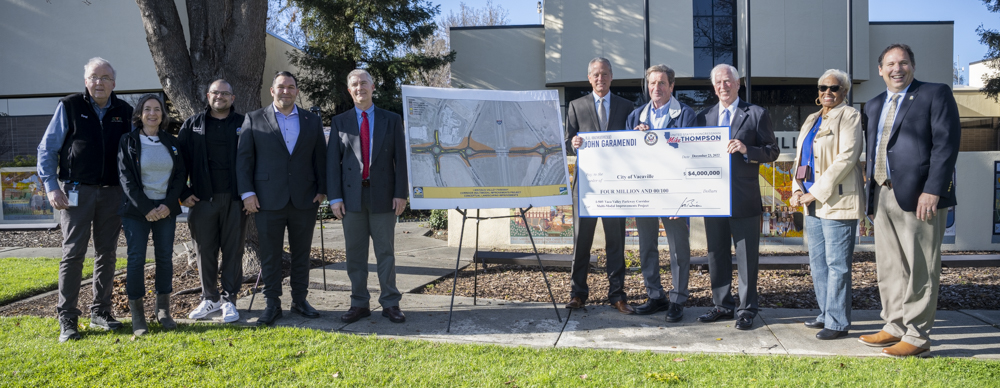 Photo of Congressmen Garamendi and Thompson with Vacaville City Council representatives, Solano Transpiration Association and City of Vacaville staff members holding large check with a rendering of the project on an a-frame.